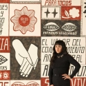 Liz Hernández standing in front her mural at the San Francisco Museum of Modern Art