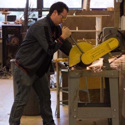 Student working saw in sculpture studio